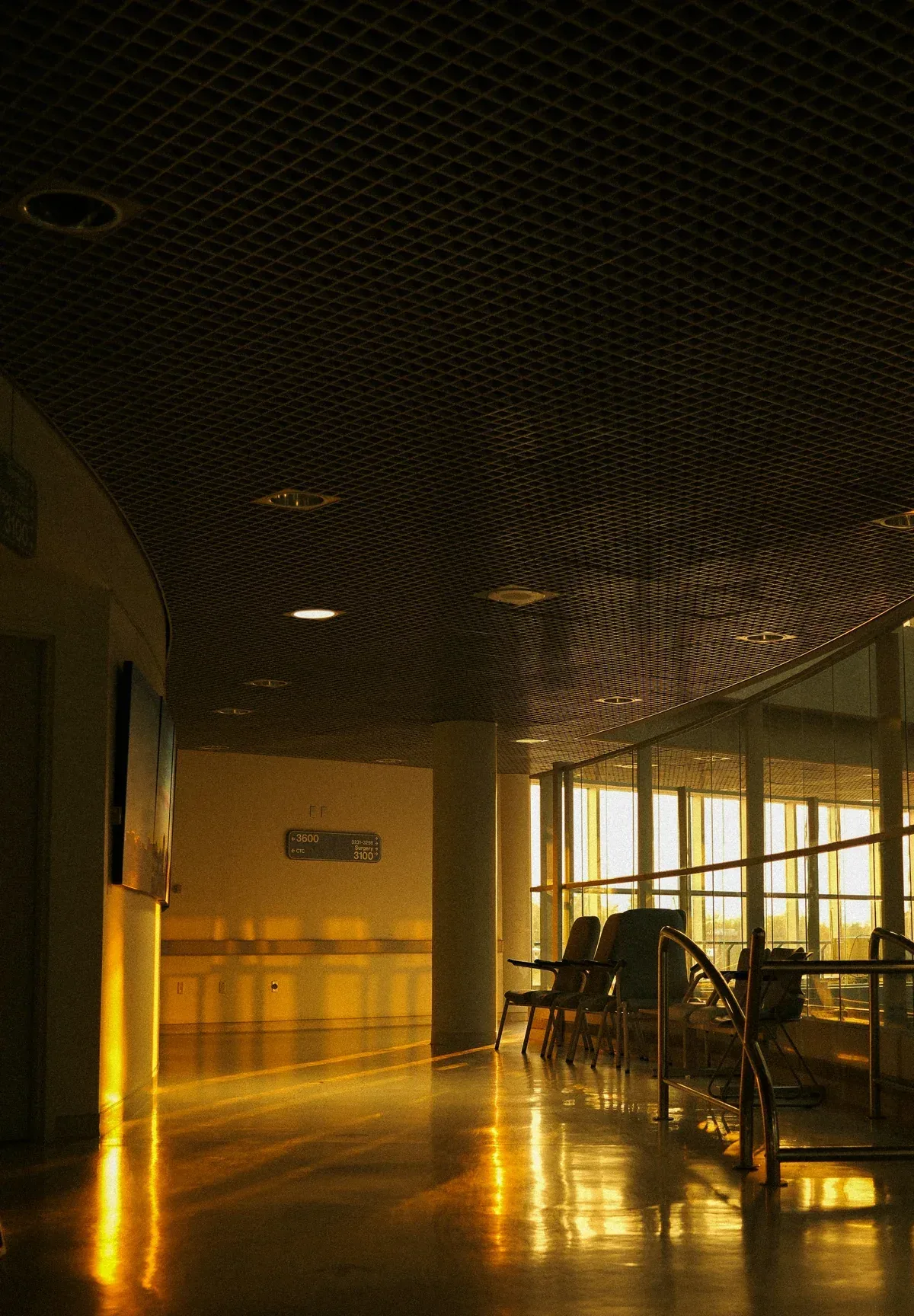 Golden late-day light filling a quiet hospital hallway