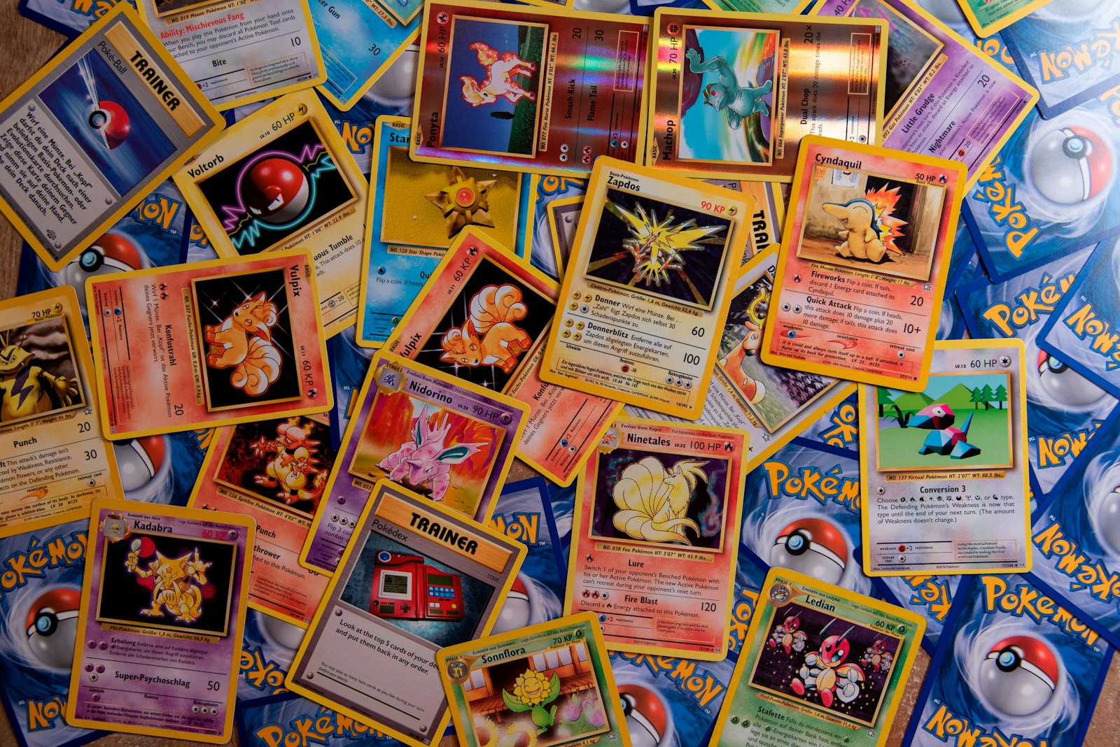 A spread of colorful trading cards covering a table