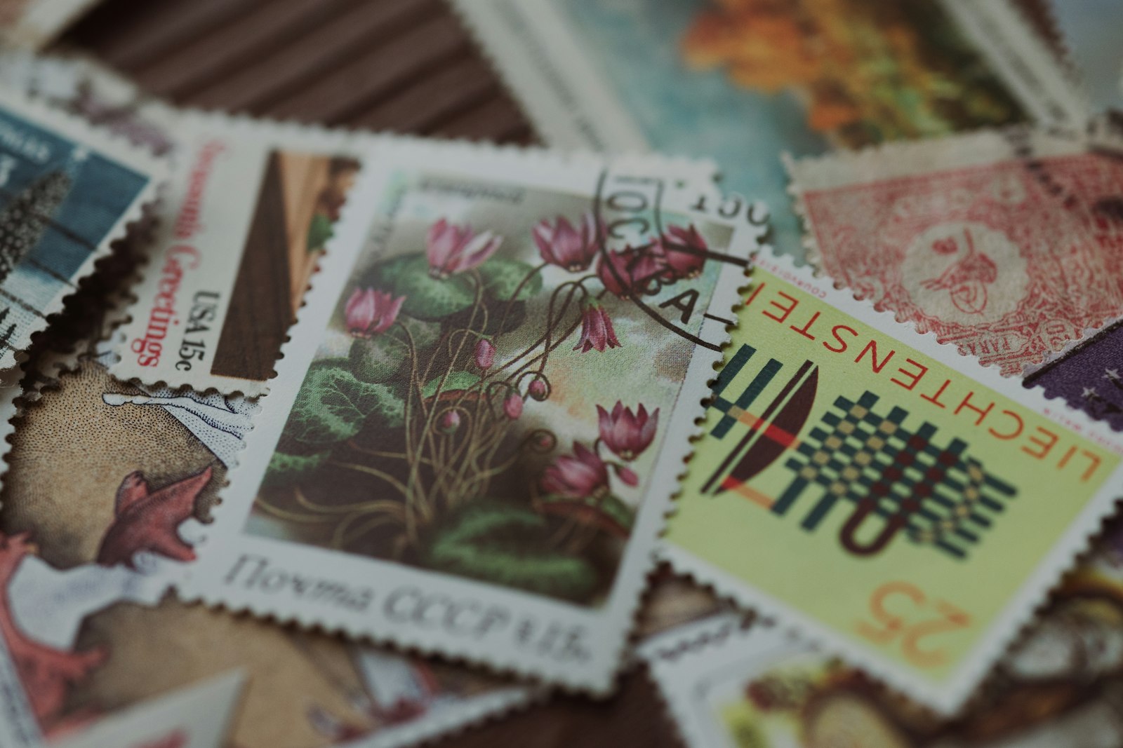 A pile of vintage postage stamps from different countries