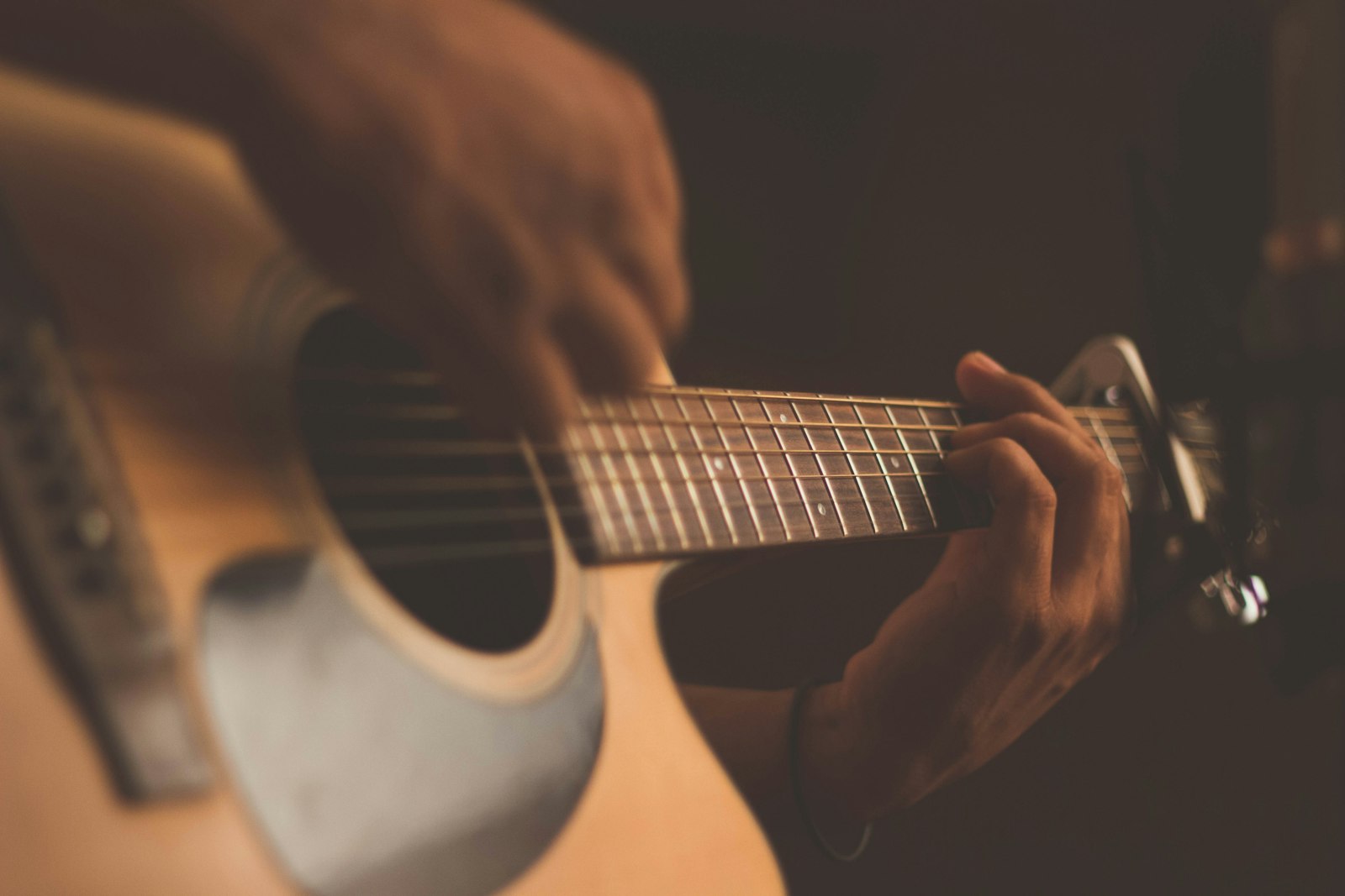 An acoustic guitar on a stand in a sunlit room
