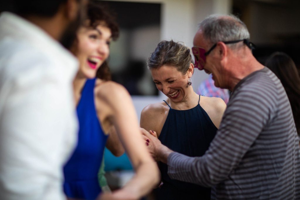Retreat participants laughing together in a playful group activity