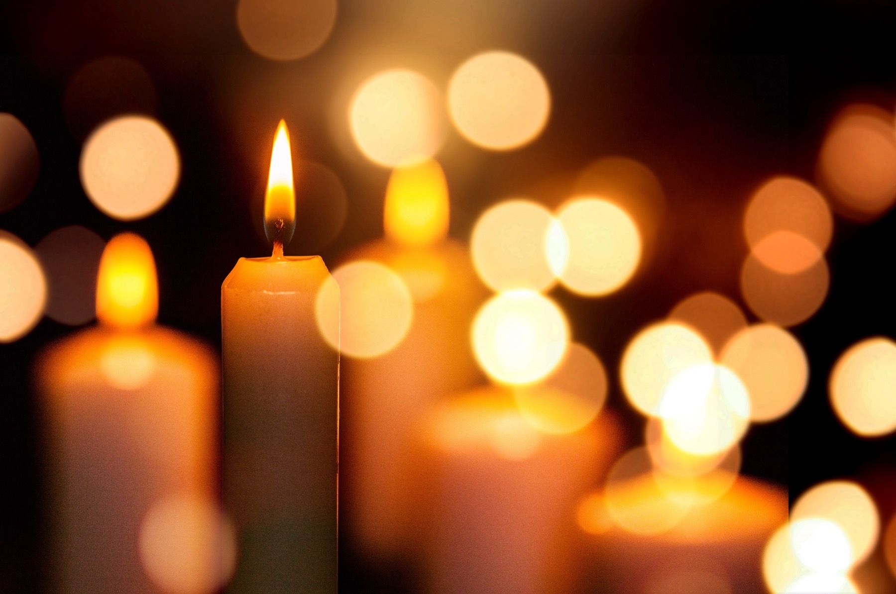 Lit candles glowing in a warm, softly blurred light