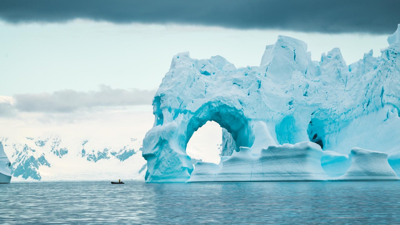 Adventurers hiking and kayaking in the stunning Antarctic landscape.