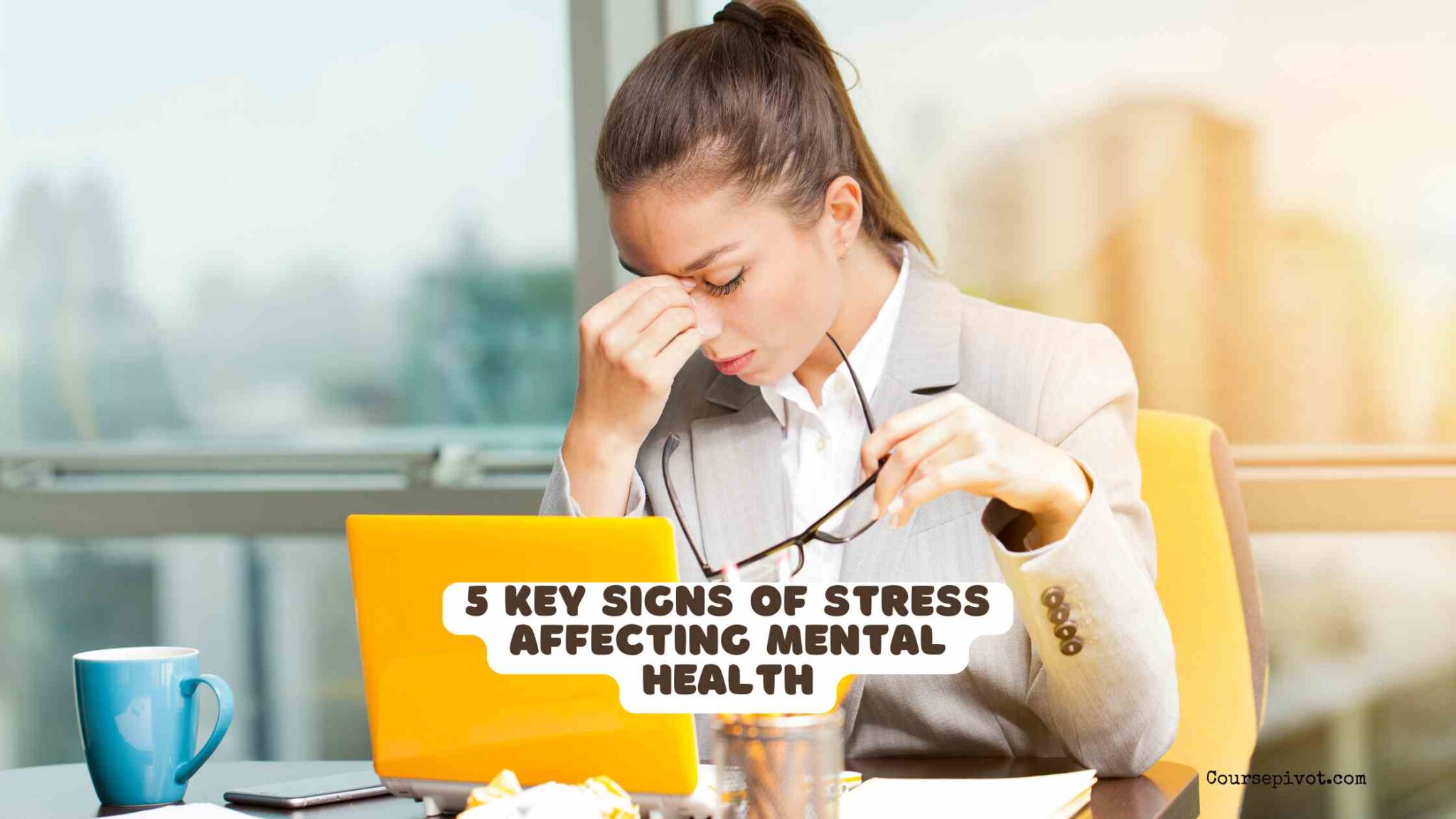 Person sitting with head in hands looking overwhelmed, representing signs of stress affecting mental health