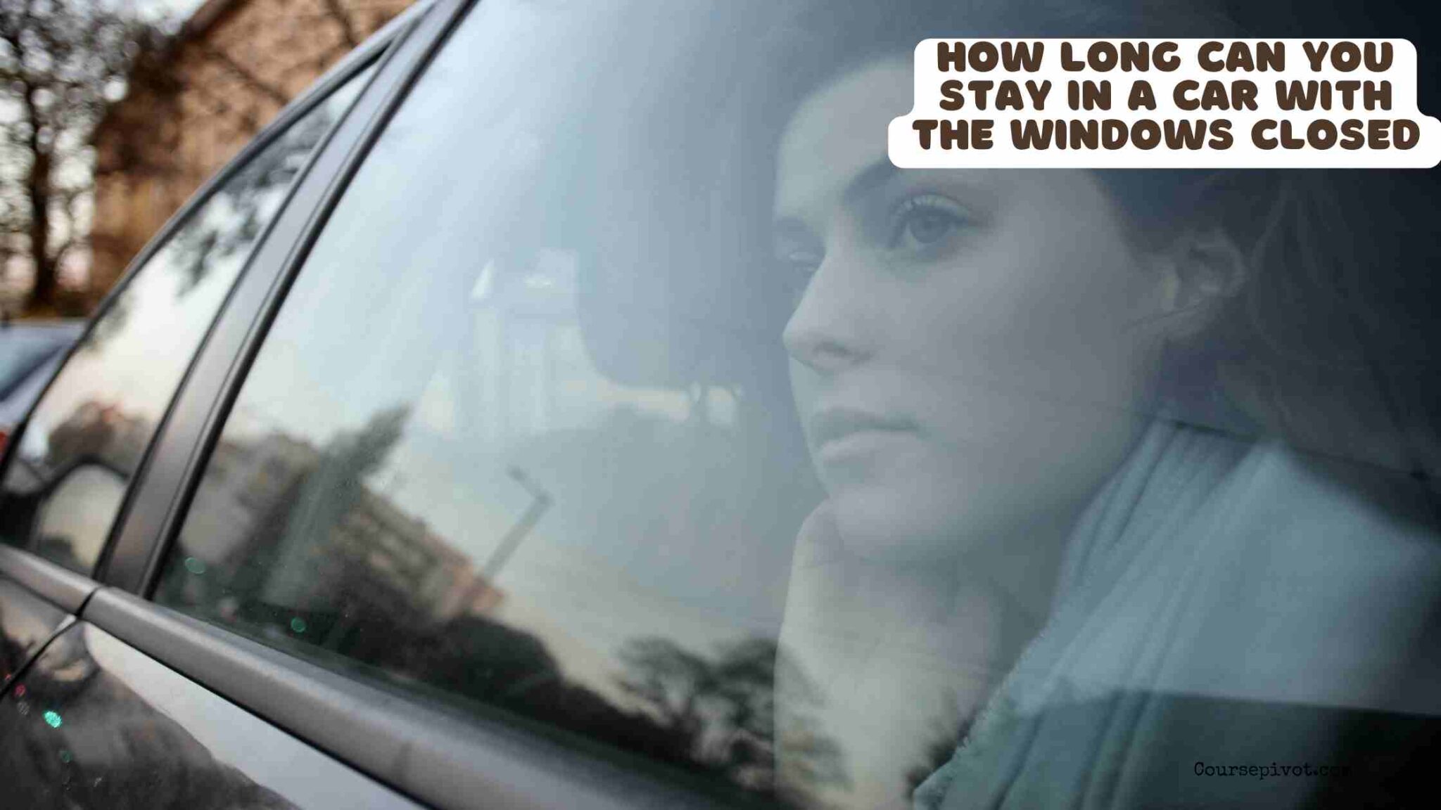 Person sitting in a parked car with closed windows on a sunny day