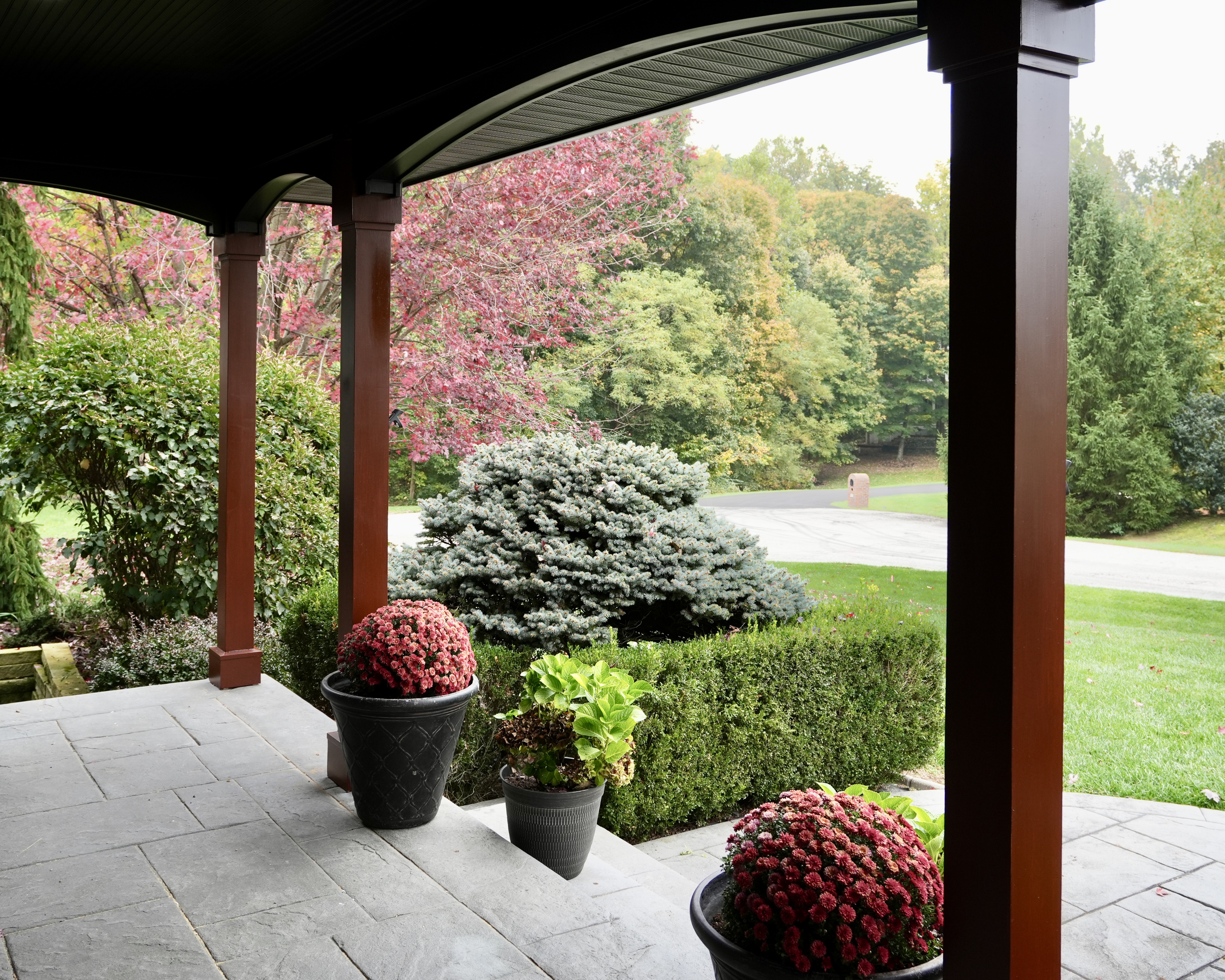 Transform your home exterior with an earthy modern paint palette. Learn how Sherwin Williams Urbane Bronze SW 7048 and Tricorn Black SW 6258 harmonize seamlessly with red brick and wooded landscapes. Discover professional painting tips on color theory, low LRV undertones, and faux stained porch columns for standout curb appeal. Read the full case study at https //craftsmanpainter.com/blog/how-sherwin-williams-urbane-bronze-sw-7048-and-tricorn-black-sw-6258-grounded-th