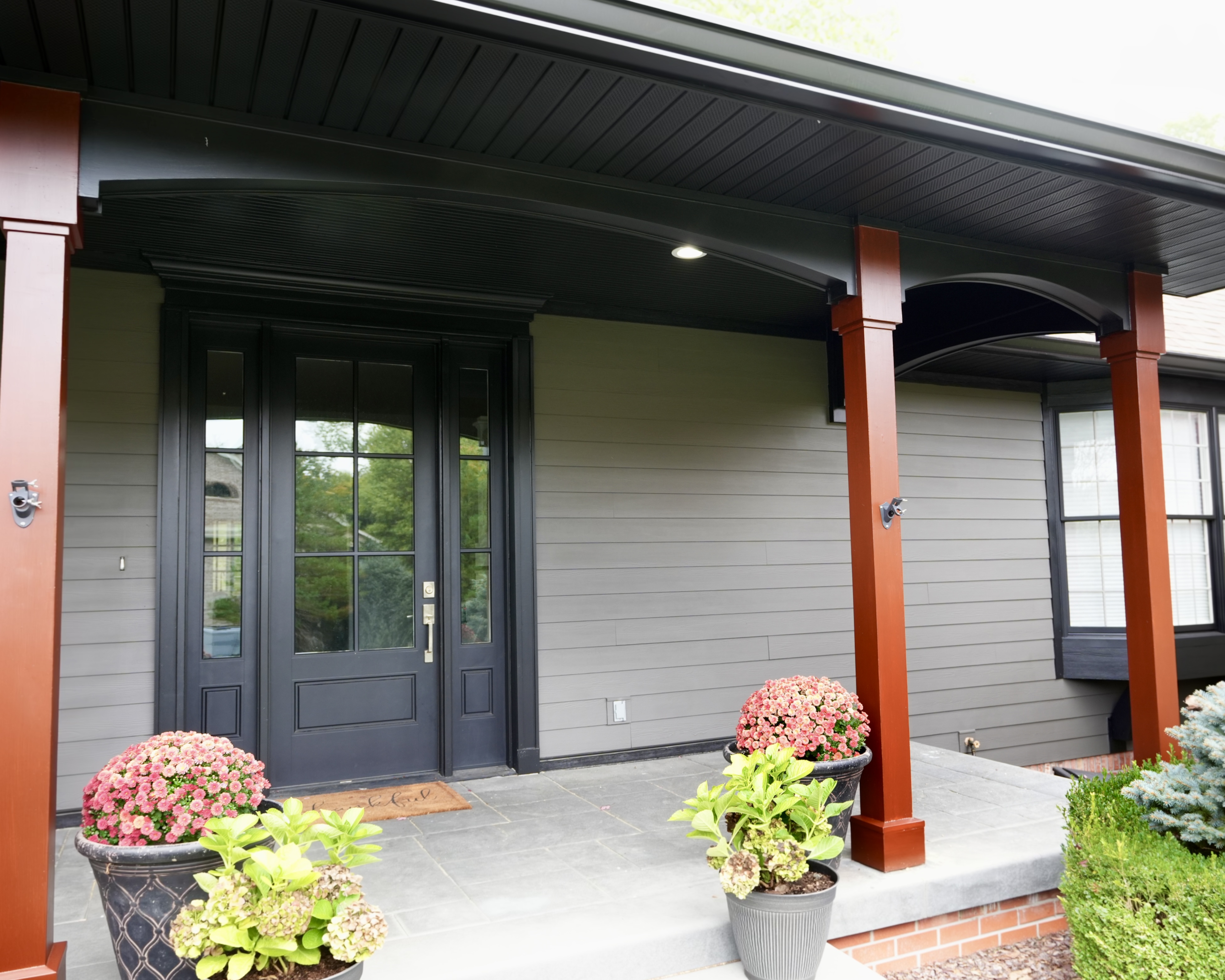 Transform your home exterior with an earthy modern paint palette. Learn how Sherwin Williams Urbane Bronze SW 7048 and Tricorn Black SW 6258 harmonize seamlessly with red brick and wooded landscapes. Discover professional painting tips on color theory, low LRV undertones, and faux stained porch columns for standout curb appeal. Read the full case study at https //craftsmanpainter.com/blog/how-sherwin-williams-urbane-bronze-sw-7048-and-tricorn-black-sw-6258-grounded-th