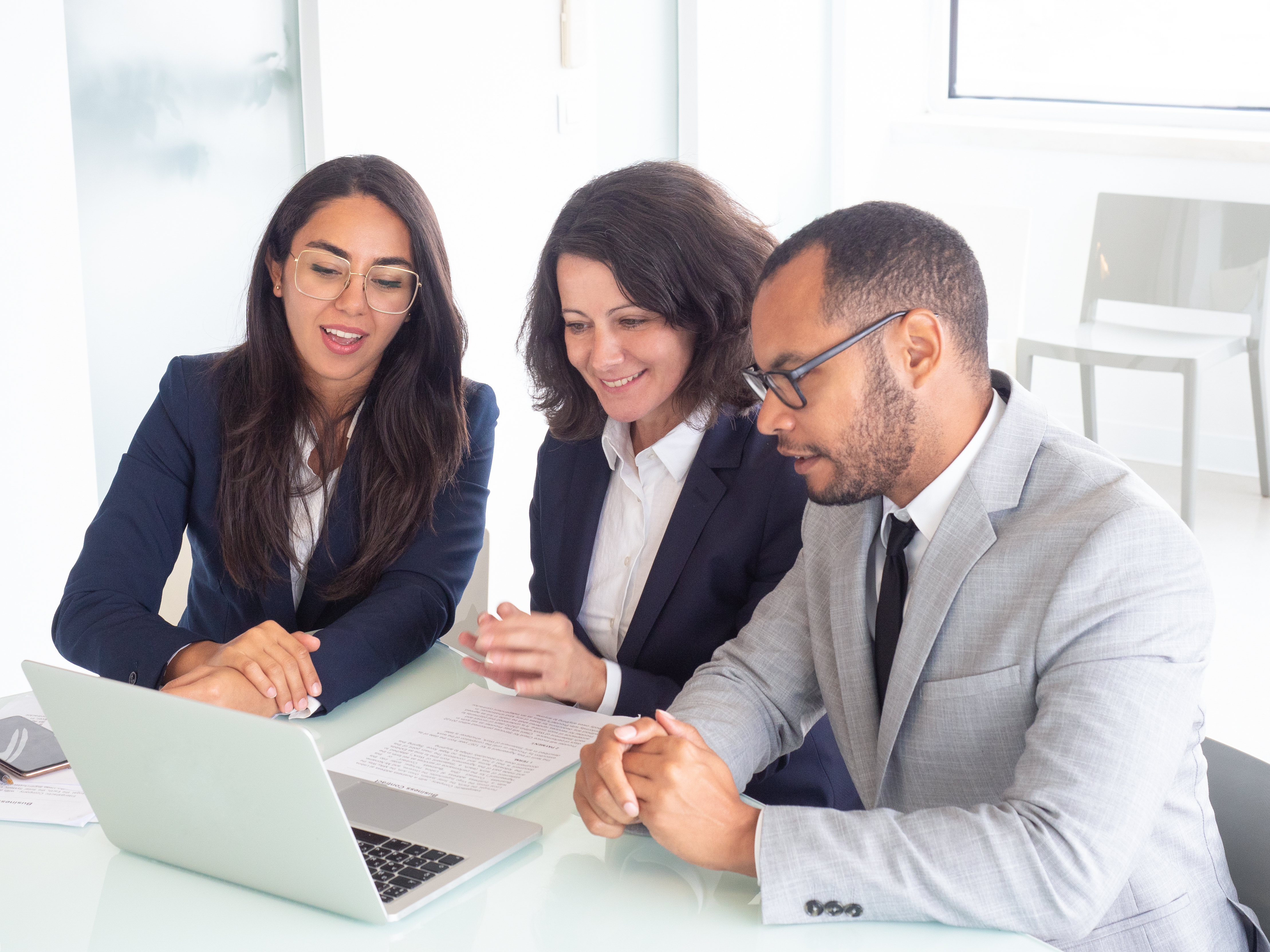 Smiling business team working on a laptop