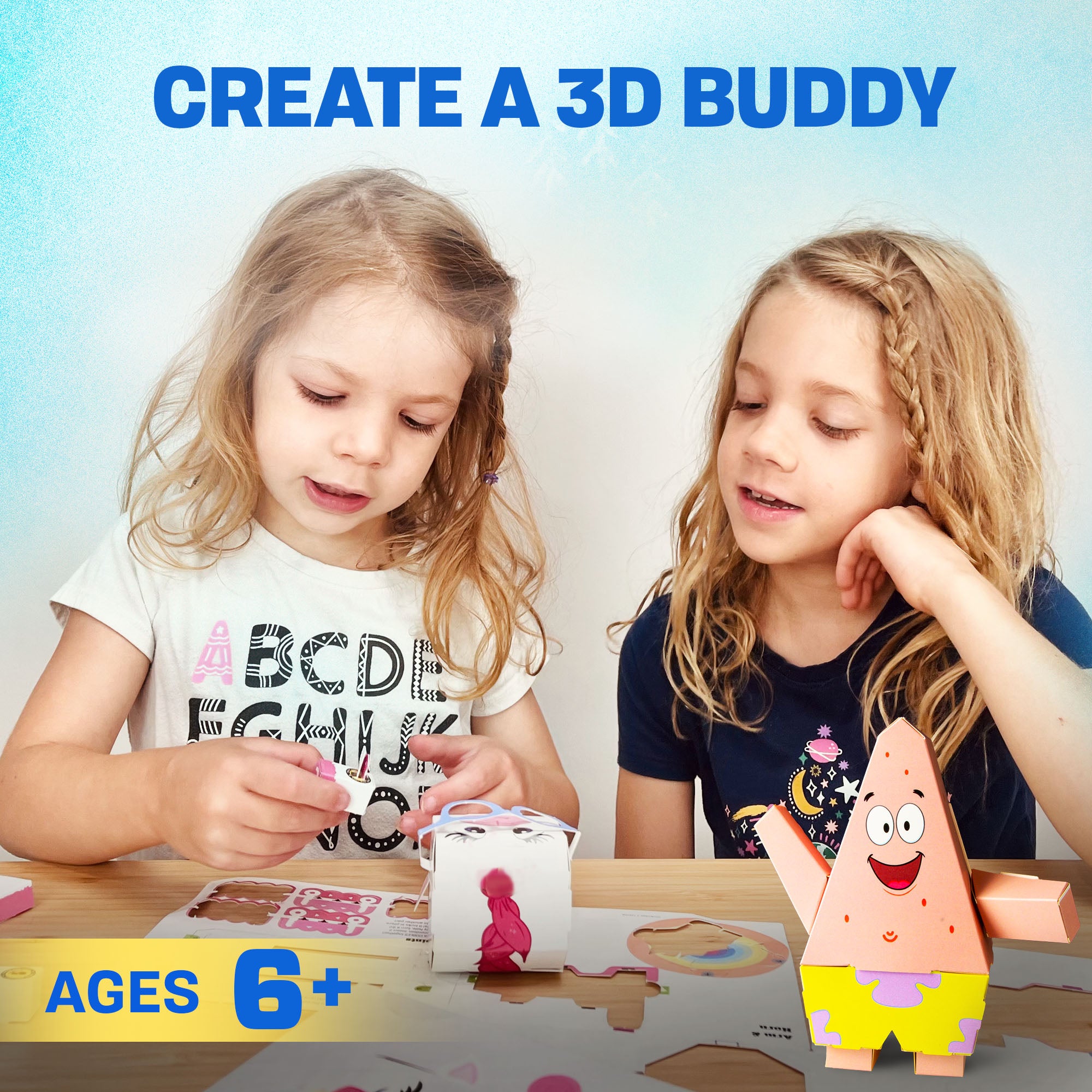 Two girls building a CUBLES Patrick Star paper craft kit, creating a 3D poseable character.