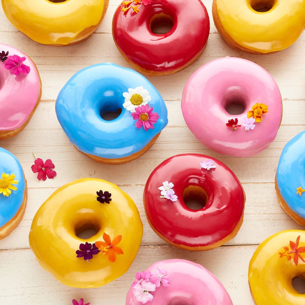 colorful glazed donuts decorated with flowers candy toppings