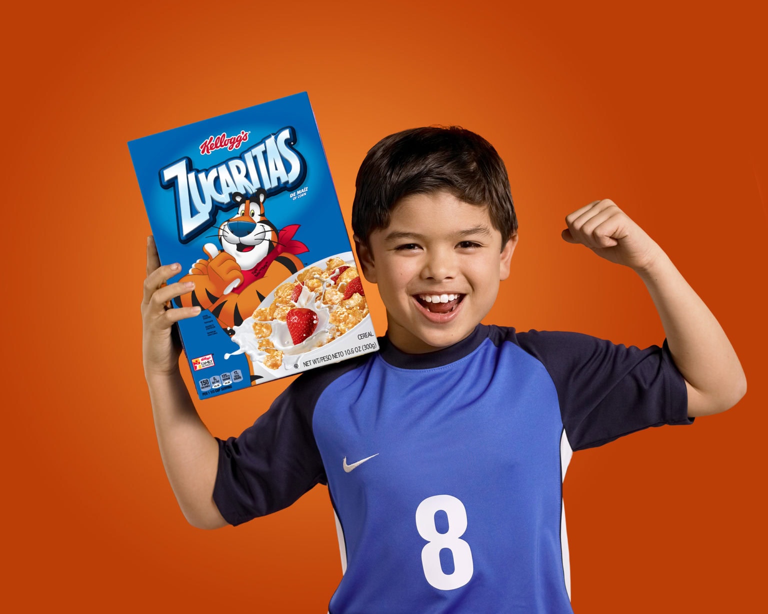 kid in sports jersey holding Zucaritas cereal box with tiger on it