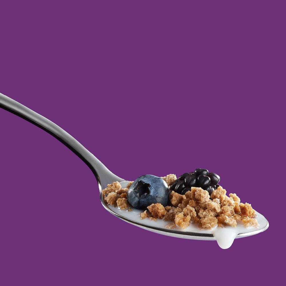 grape nuts cereal on spool with berries and milk