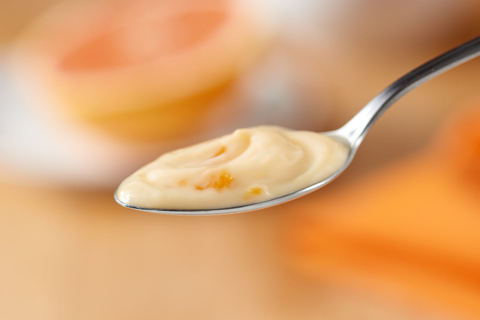 peach yogurt on spoon