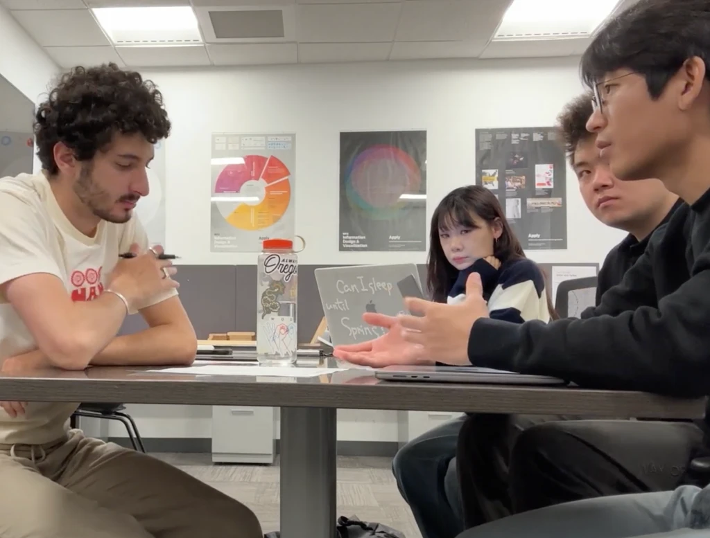 Nancy's interview: the research team gathered around a table, a laptop and notes between them