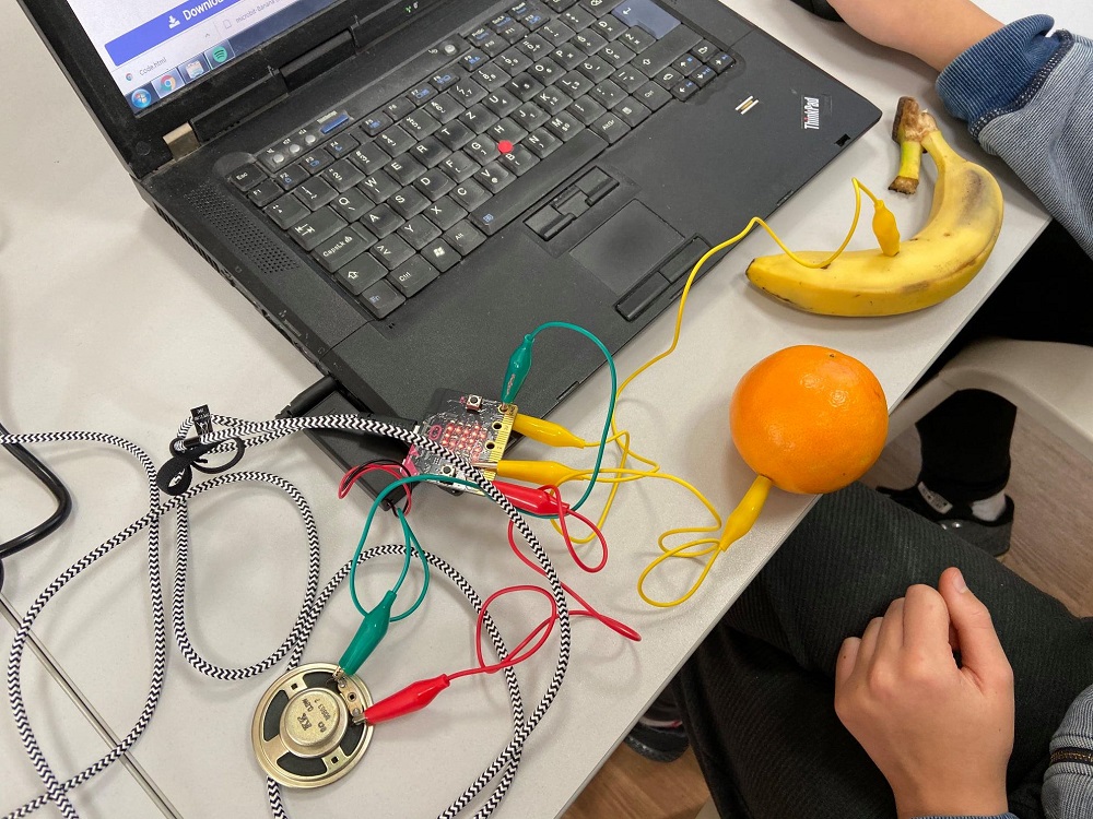 Banana and orange powering a mini computer.