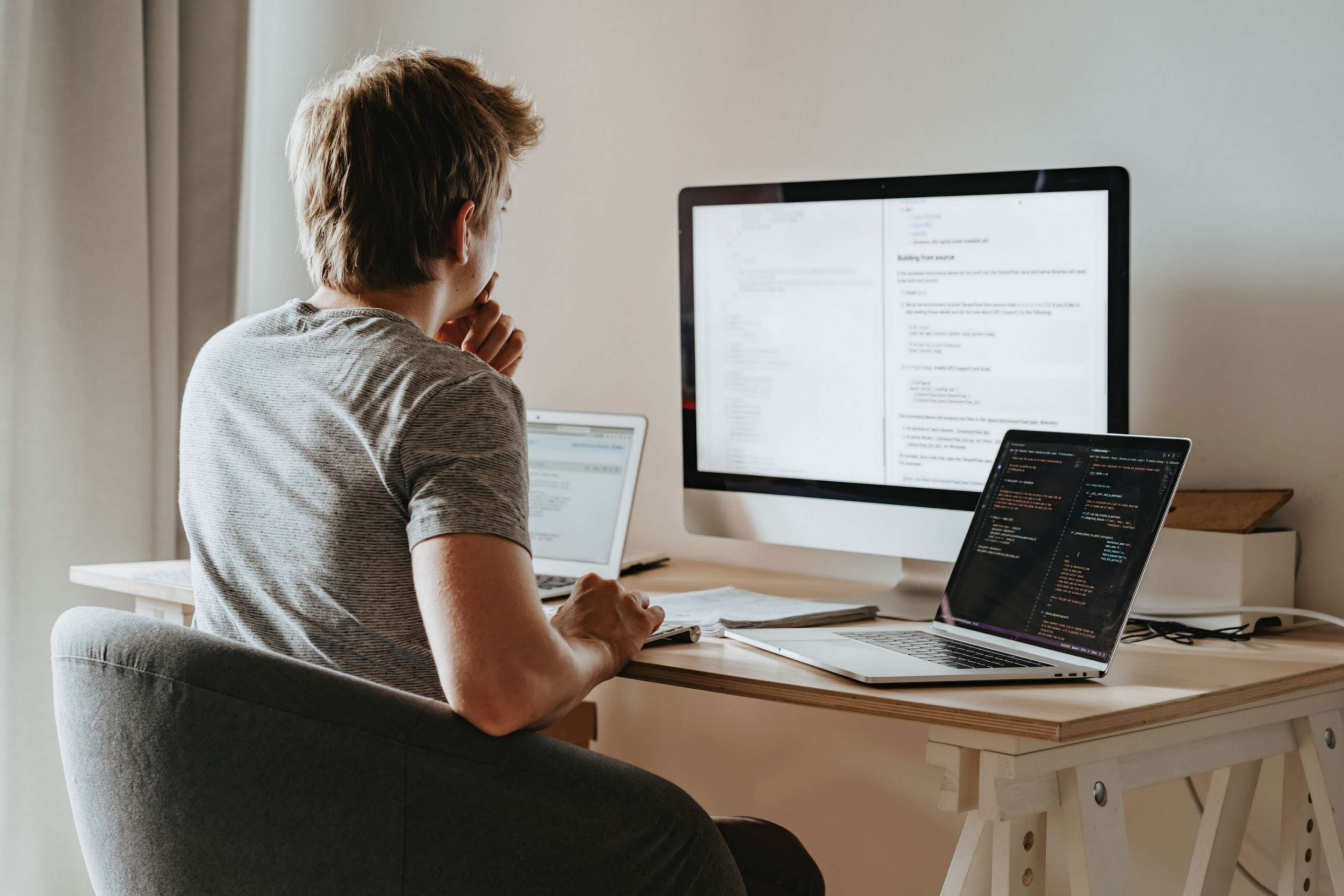 Photo by olia danilevich: https://www.pexels.com/photo/man-sitting-in-front-of-three-computers-4974915/