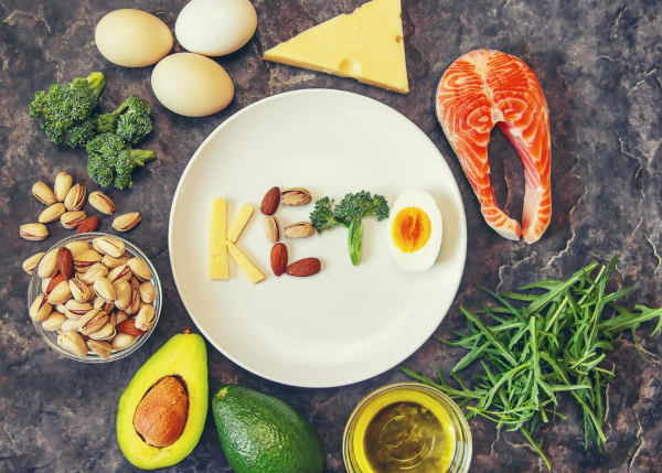 Fresh keto-friendly vegetables including avocados, leafy greens, and bell peppers