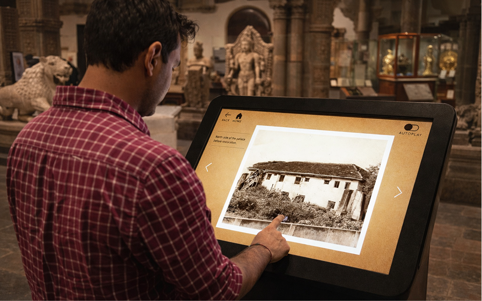 Interactive tilted touchscreen kiosk showing historical photography