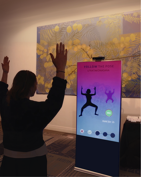 Person gesturing toward a vertical digital display