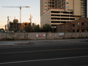 A construction fence with graffiti on it in downtown Phoenix. 