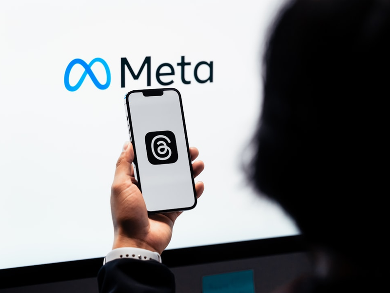 Young man using new meta threads app on smartphone