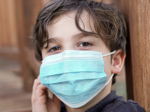 Young boy wearing a blue mask