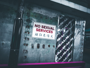 a no sexual services sign is posted on a wall