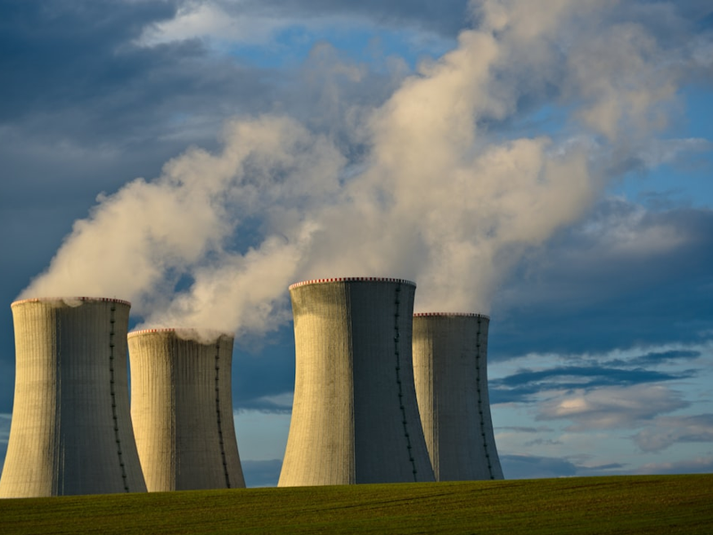 gray concrete towers under white clouds and blue sky during daytime