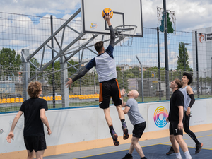 Basketball player jumps to shoot a basket.