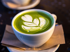 white ceramic teacup filled of matcha tea