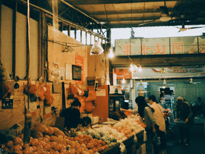 People shopping at a busy outdoor market.