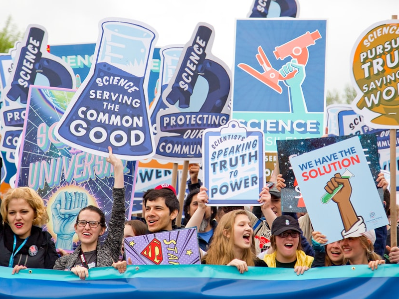 group of people with signages