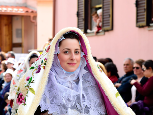 a woman in a white dress and a purple shawl