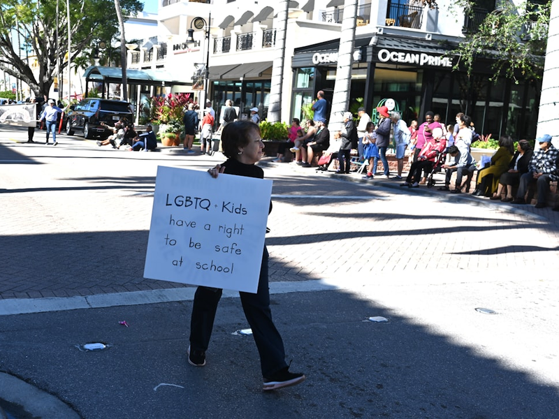 Naples, Florida, USA-January 16, 2023: A woman with a LGBTQ sign at the Martin Luther King, Jr. Parade. Editorial use only.