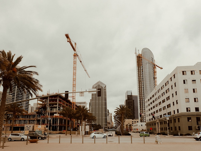 people walking on street near high rise buildings during daytime