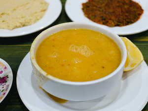 Lentil soup with accompaniments is ready to eat.
