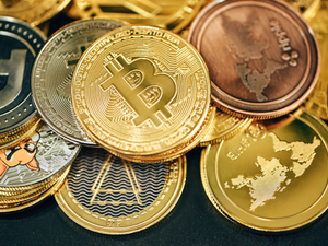 A pile of cryptocurrencies placed on a black background