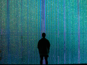 a person standing in front of a wall of lights