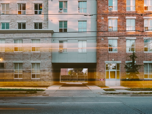 School bus goes by LIFT, affordable housing, in downtown London Ontario - King Street.