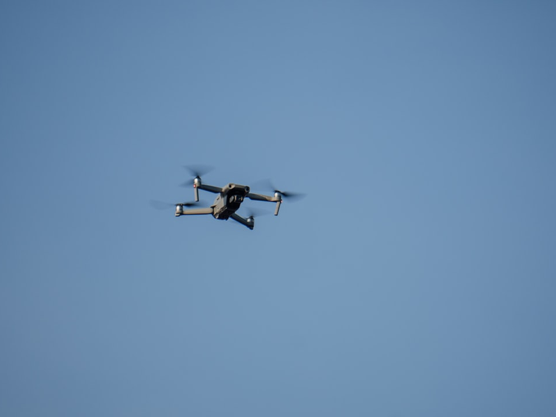 a small plane flying through a blue sky