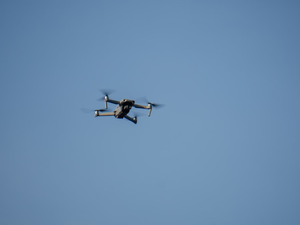 a small plane flying through a blue sky