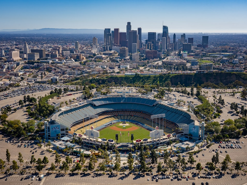 an aerial view of a baseball stadium with a city in the background