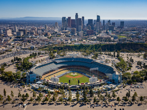 an aerial view of a baseball stadium with a city in the background