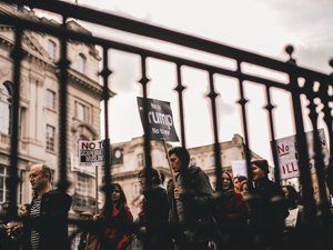 people walking with signs at the city during day
