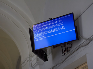 The TV displays a blue screen of death.
