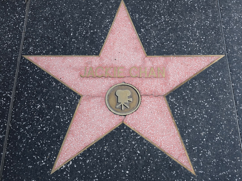 a pink and white star with Hollywood Walk of Fame in the background