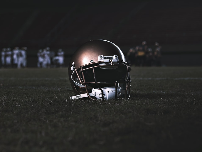 football helmet on green grass field during night time