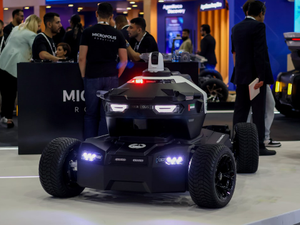 Autonomous security robot vehicle showcased at a technology exhibition, highlighting robotics innovation, smart surveillance systems, and advanced mobility solutions in a modern expo setting.