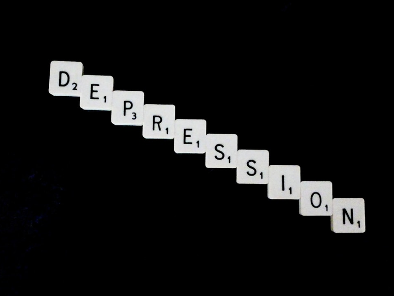 Depression, spelled out in white scrabble tiles.