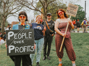 Protestors rally with signs advocating for social change.